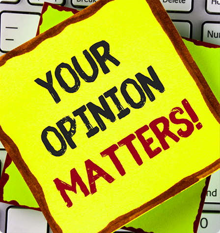 A stack of Sticky Note pads with the phrase "Your Opinion Matters" written in block letters on the top pad.
