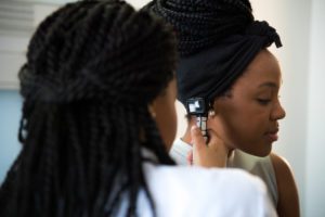 Doctor examining a patient's ear