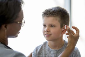 Hearing loss specialist examines the child hearing loss problem