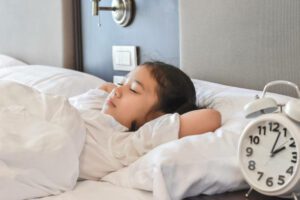 Happy school students well asleep enough relaxation at night in bedroom hotel