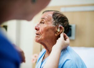 Elderly man wearing hearing aid