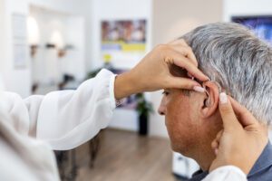 Hearing Loss specialist Checking patient ear