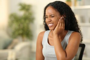 Black woman suffering tinnitus at home