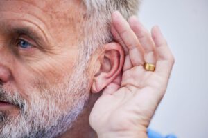 Senior man with hearing loss in one ear.