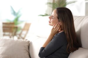 Stressed woman suffering earache at home