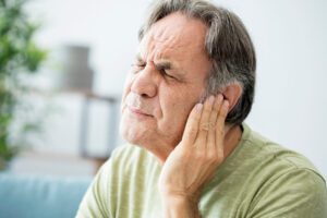 Old man with ear pain and ear ache
